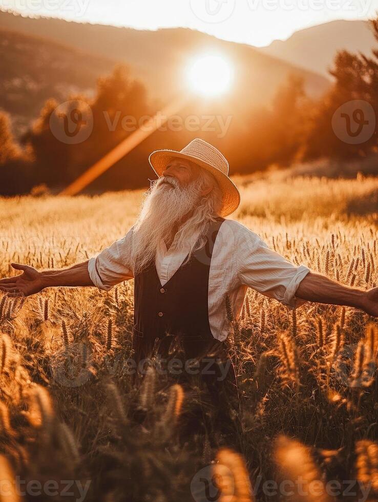 Elderly man in sunlit wheat field photo
