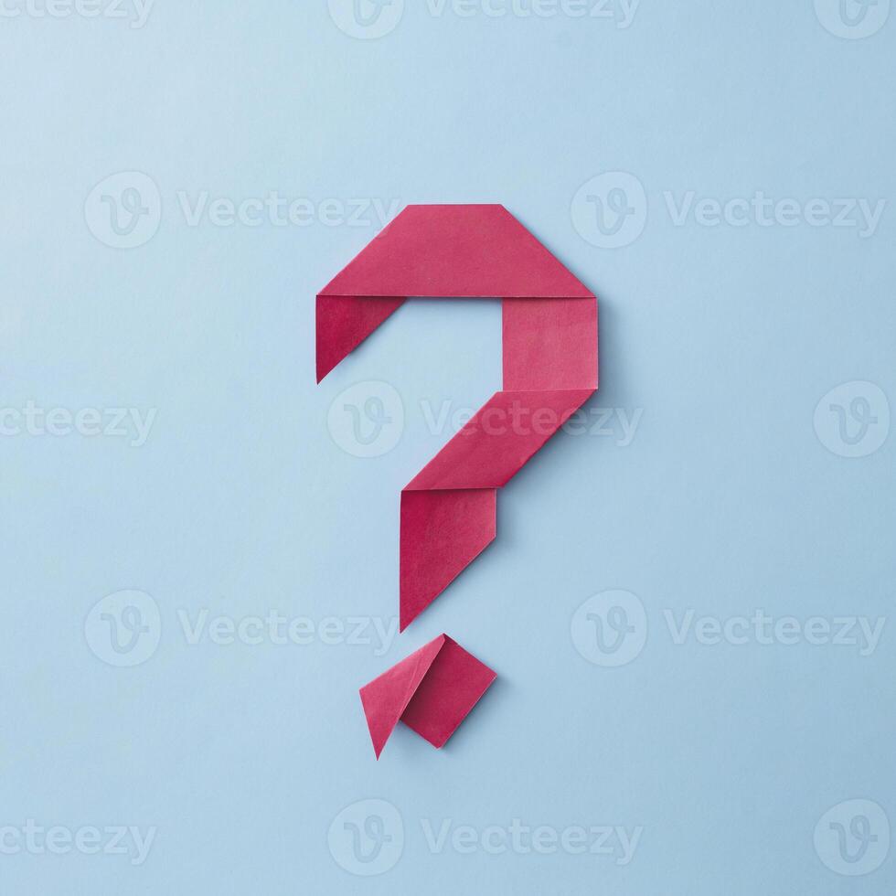 Neatly folded origami red paper question mark photo