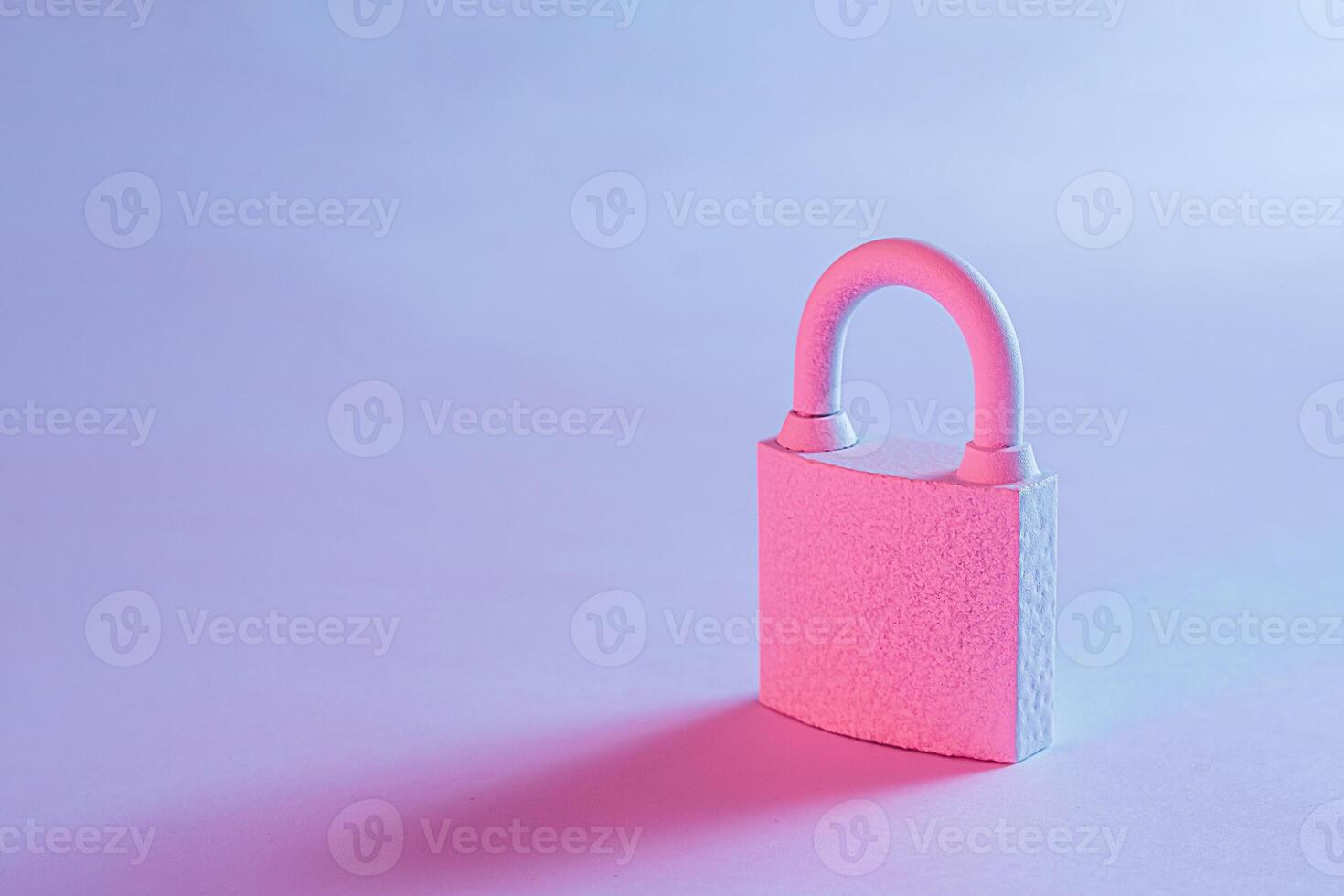 Close-up of a lockpad with shadow on studio blue background photo