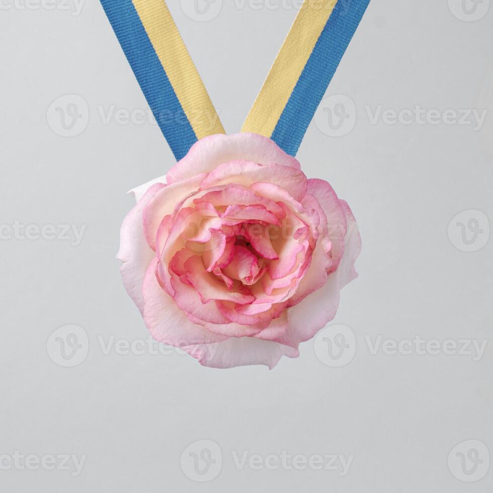 Rose as the reward of the champion and the winner on the ribbon of the medal. Victory and Success. photo