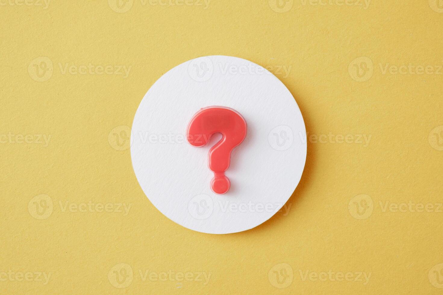 A question mark in a white circle on a yellow background Question and answer solution search concept photo