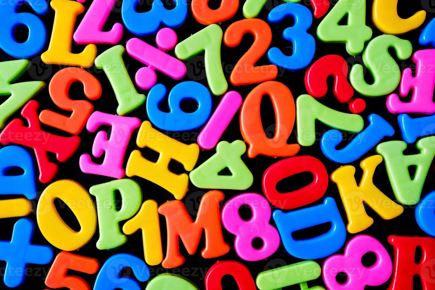 Background with letters and symbols as a school education concept. Cheerful bright letters. photo