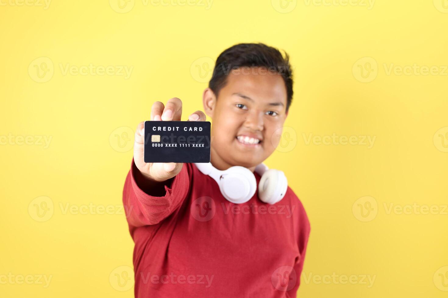 Overweight Asian Boy Holding Black Card photo