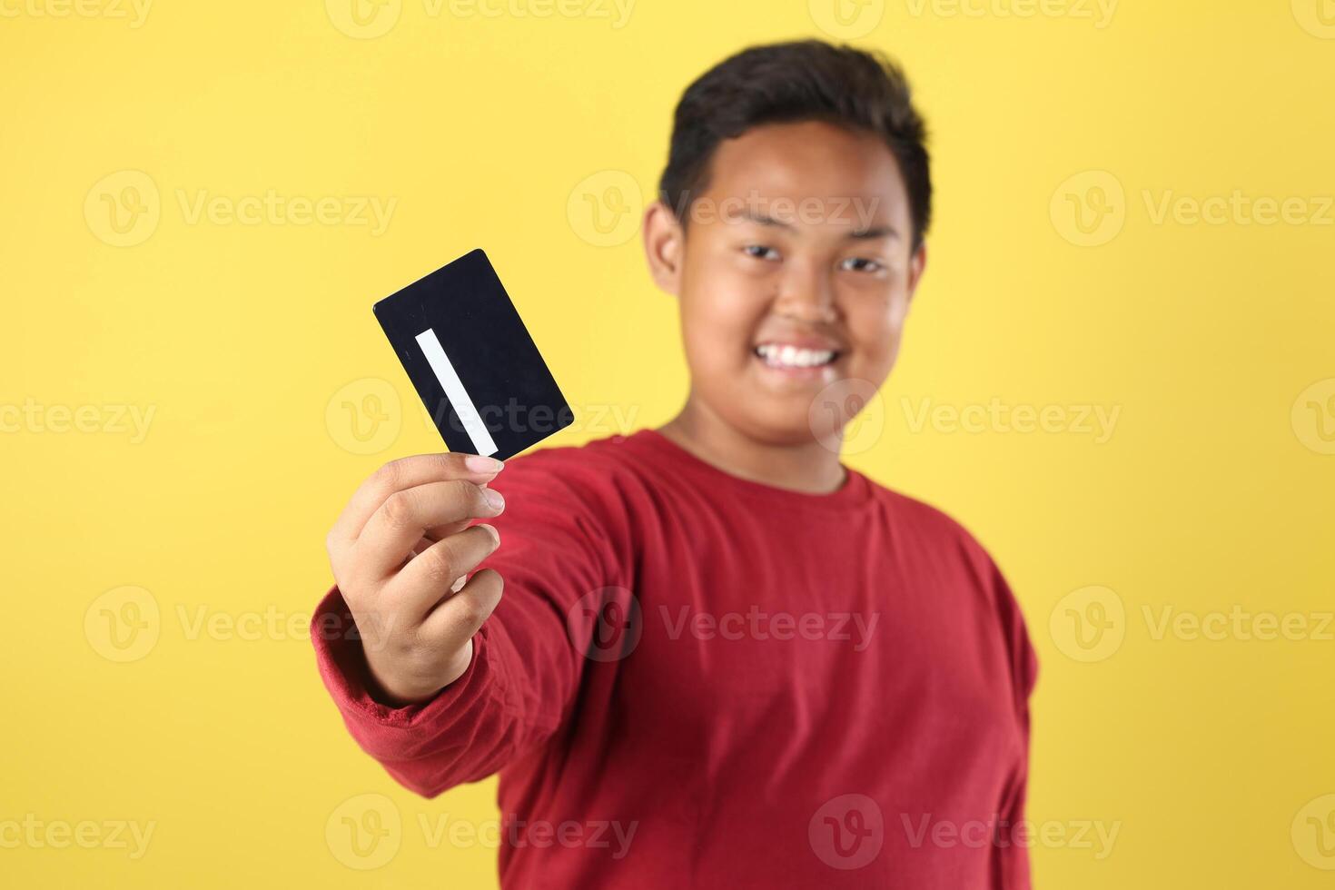Overweight Asian Boy Holding Black card Above His Head photo