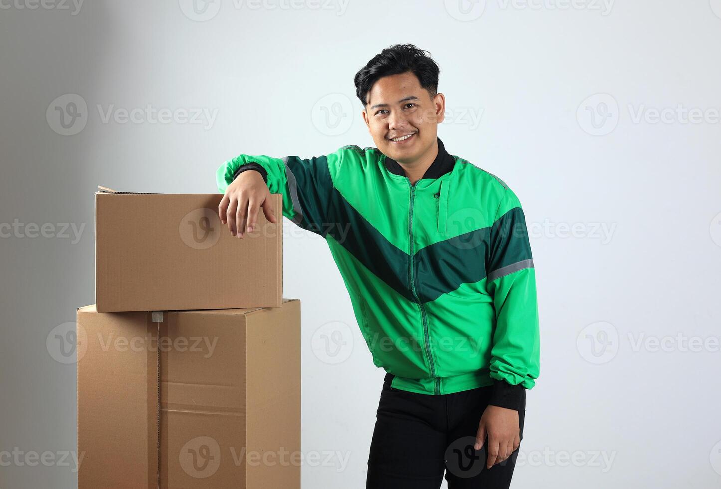 Online Driver Pose on Stacked Cardboard, Gojek Grab Delivery Concept Online Shopping photo