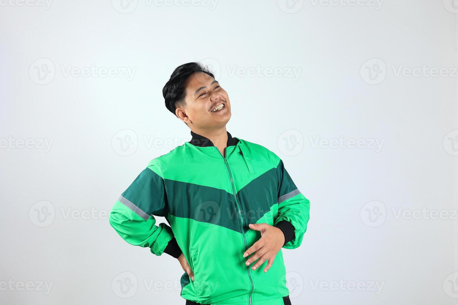 Adult Asian Indonesian Man Touching his Belly with Relieved Expression photo