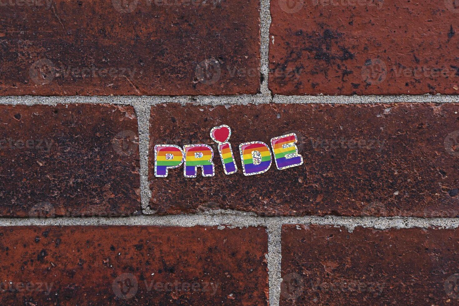 Rainbow Pride Sticker on Red Brick Wall photo