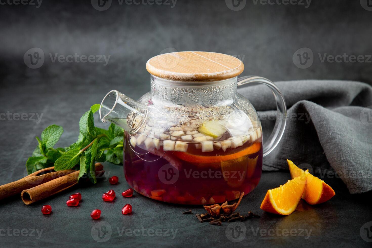 hot homemade tea with cinnamon, lemon and mint side view photo