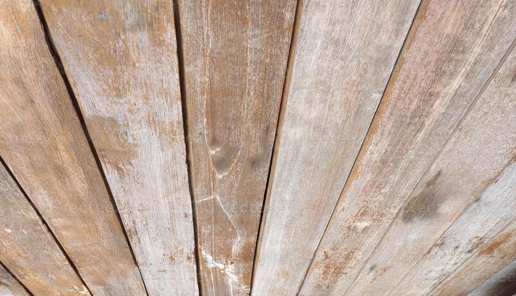 A wall picture made of old light-colored wooden panels arranged in a row photo