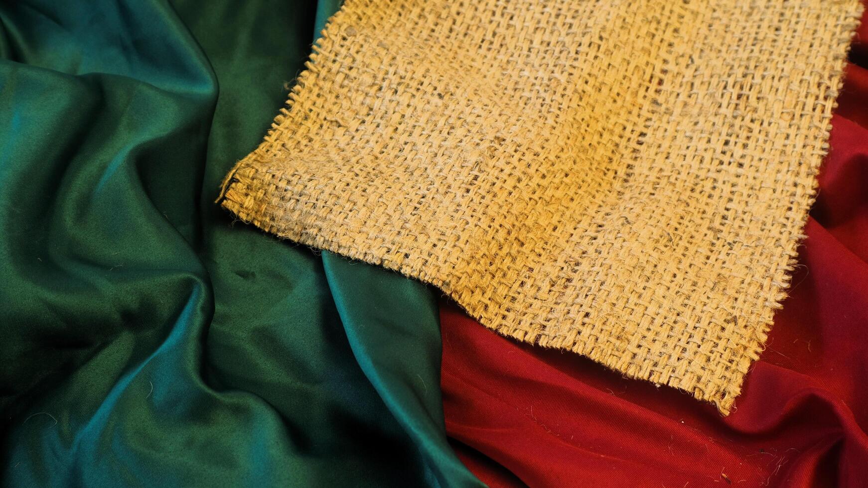 A rustic vintage burlap featuring green and red plain fabric, copy space for minimalist christmas greeting design textured background photo