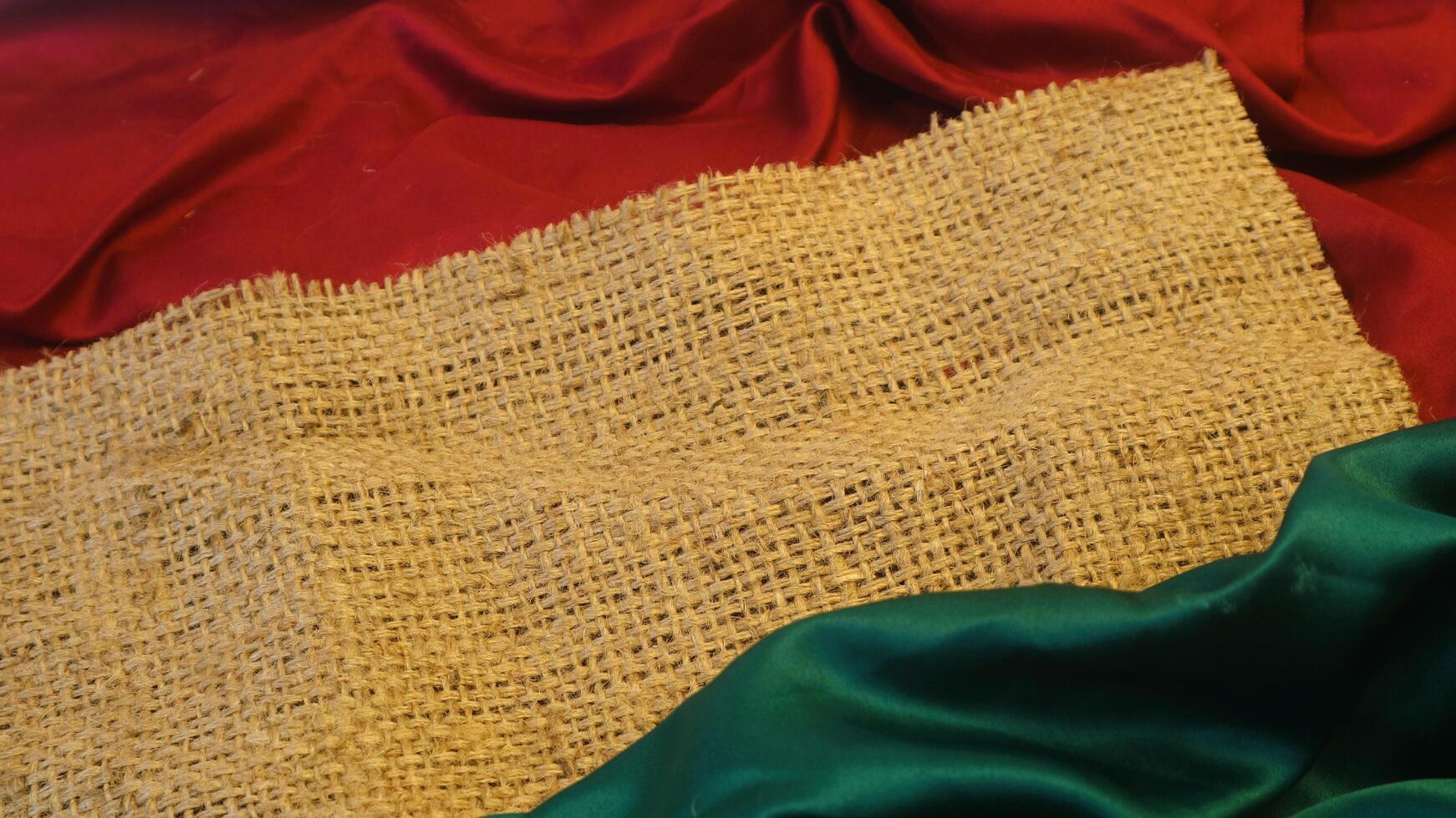 A rustic vintage burlap featuring green and red plain fabric, copy space for minimalist christmas greeting design textured background photo