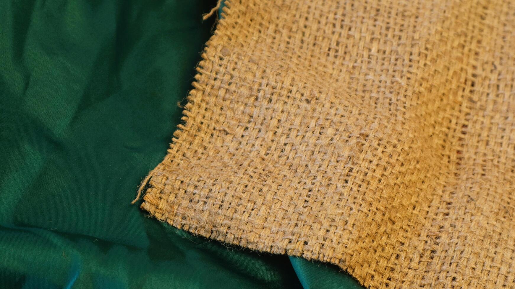 A rustic vintage burlap featuring green and red plain fabric, copy space for minimalist christmas greeting design textured background photo