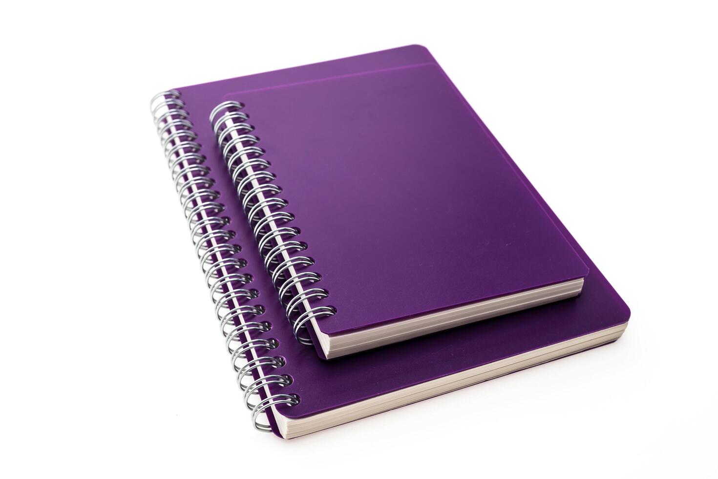 A purple notebook with a spiral bound cover photo