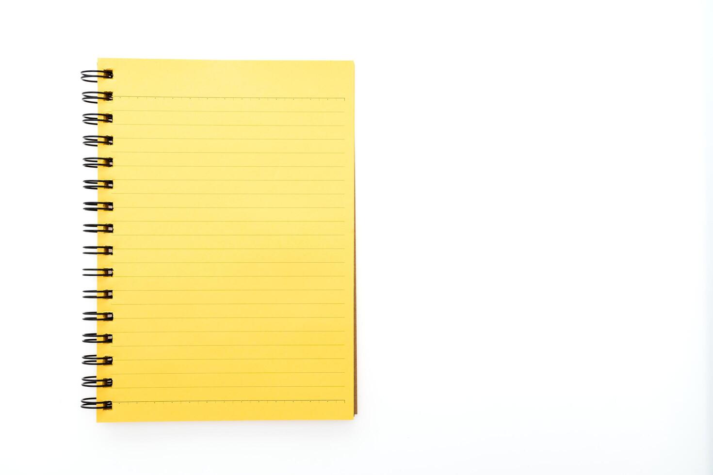 Yellow notebook on white background photo