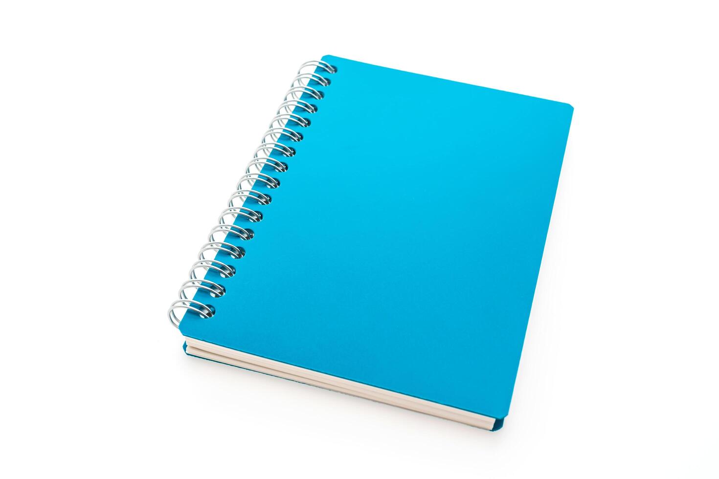A blue notebook on a white surface photo