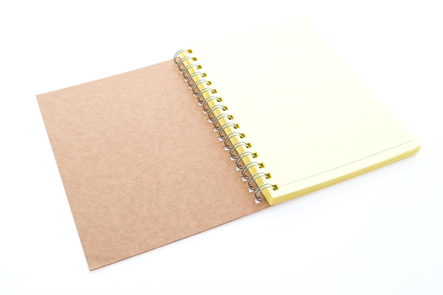 A notebook with a spiral bound cover and a yellow notepad photo