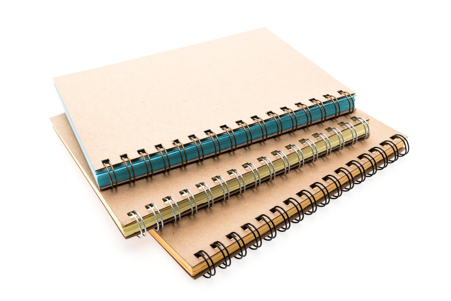 Three notebooks with spiral binding on a white background photo