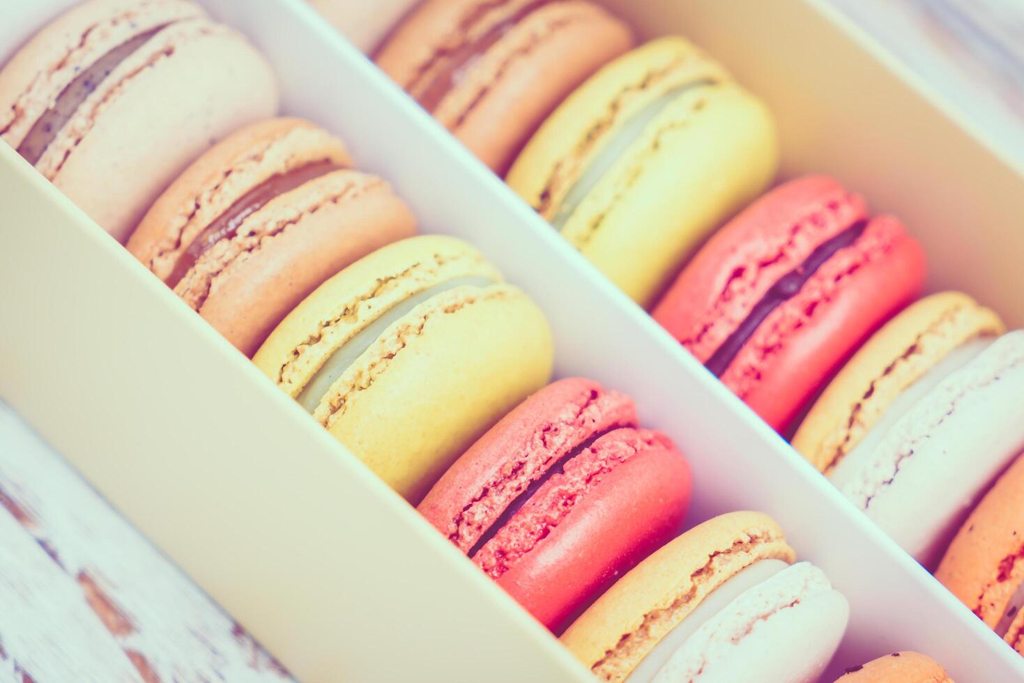 A box of macarons is shown with a variety of colors photo