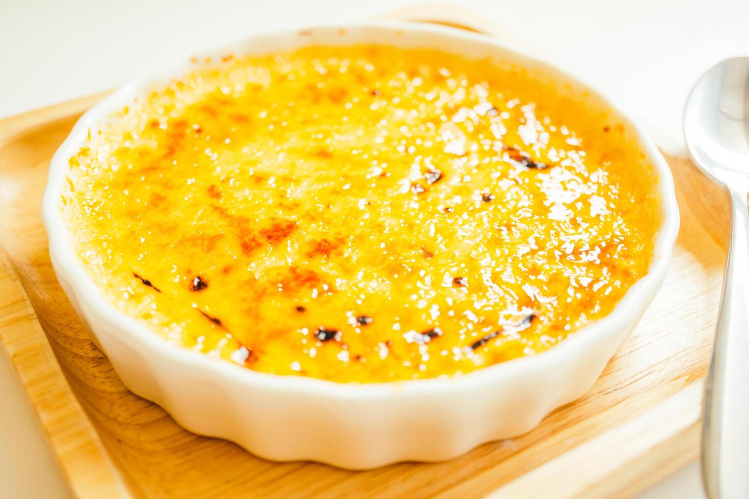 A bowl of food on a table with a spoon photo