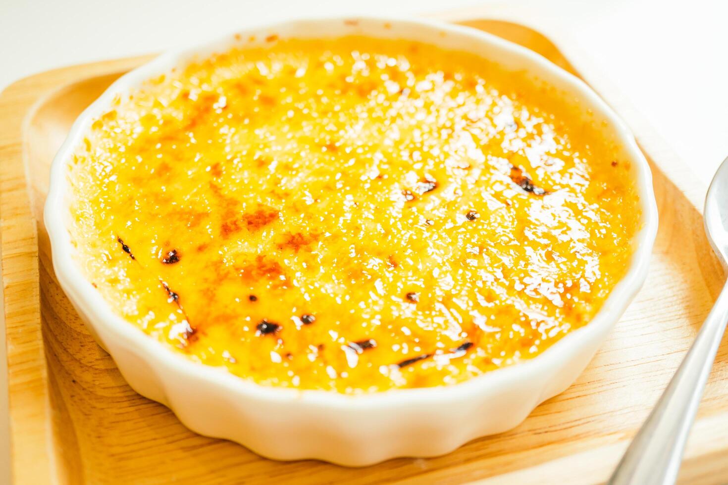 A bowl of food on a table with a spoon photo