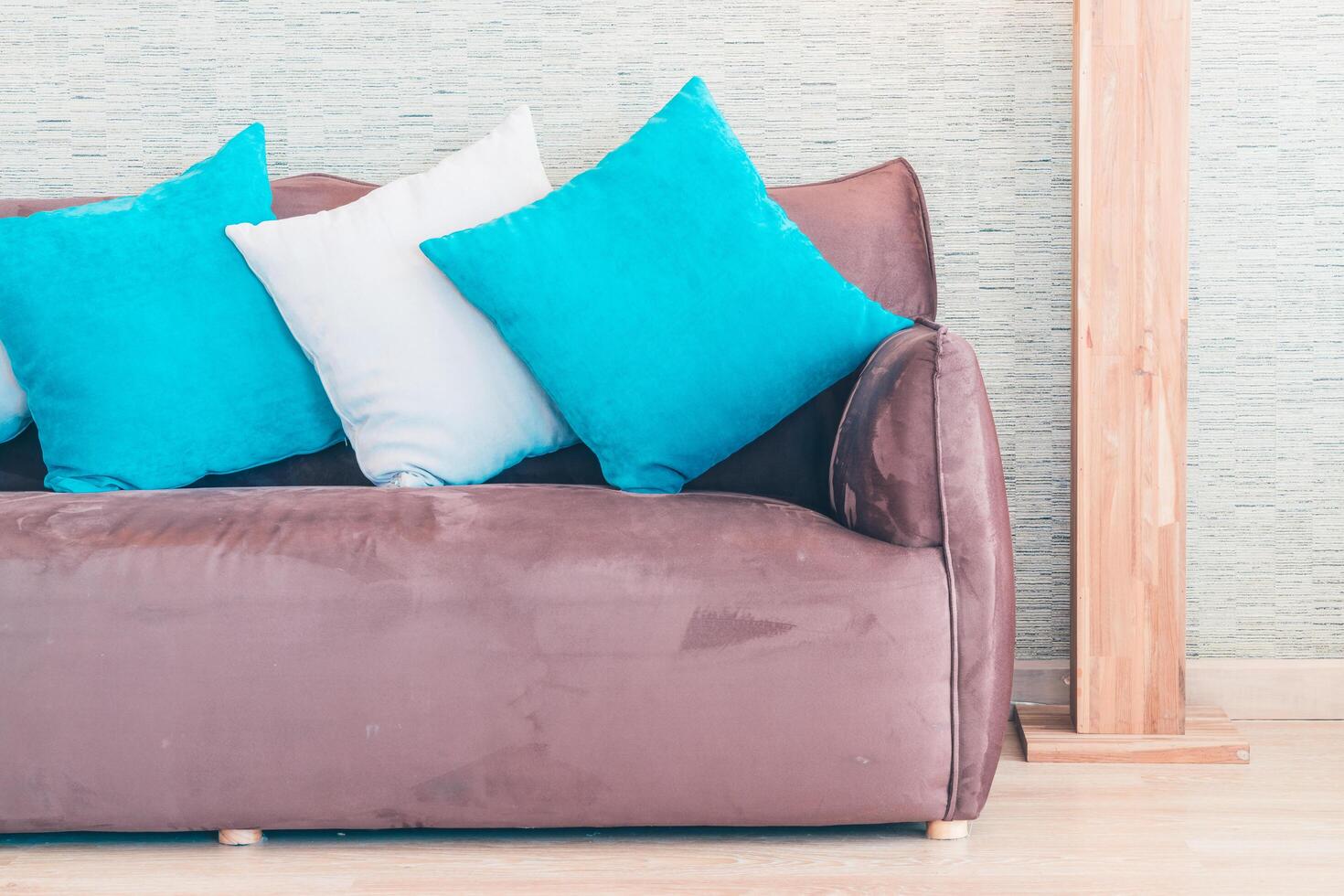 A brown couch with blue pillows photo
