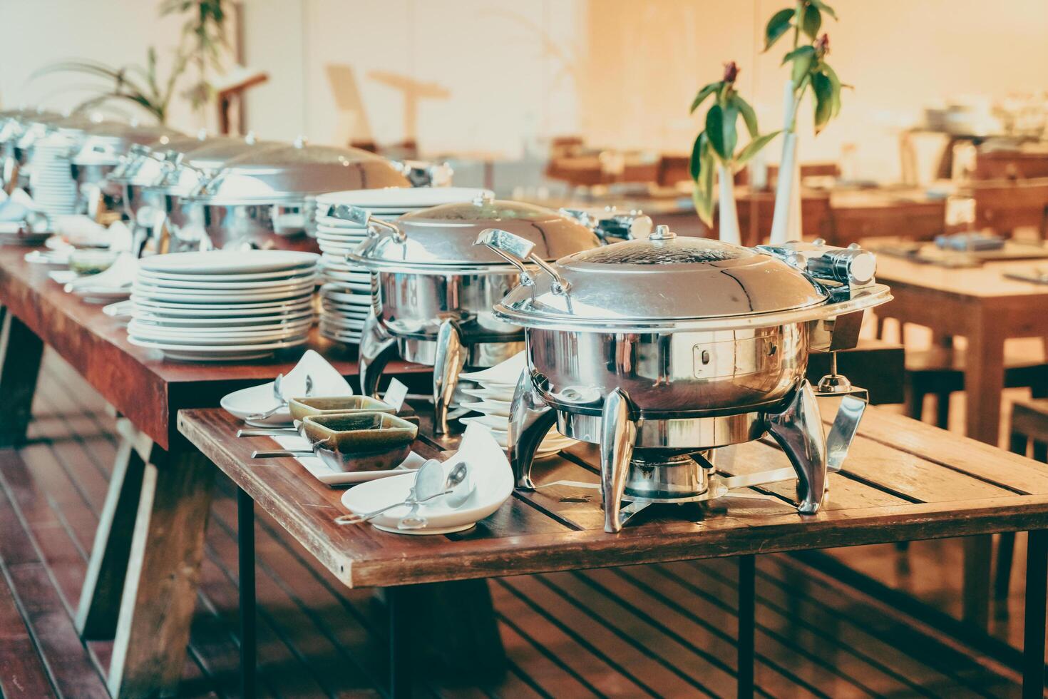 A buffet table with silver dishes and plates photo