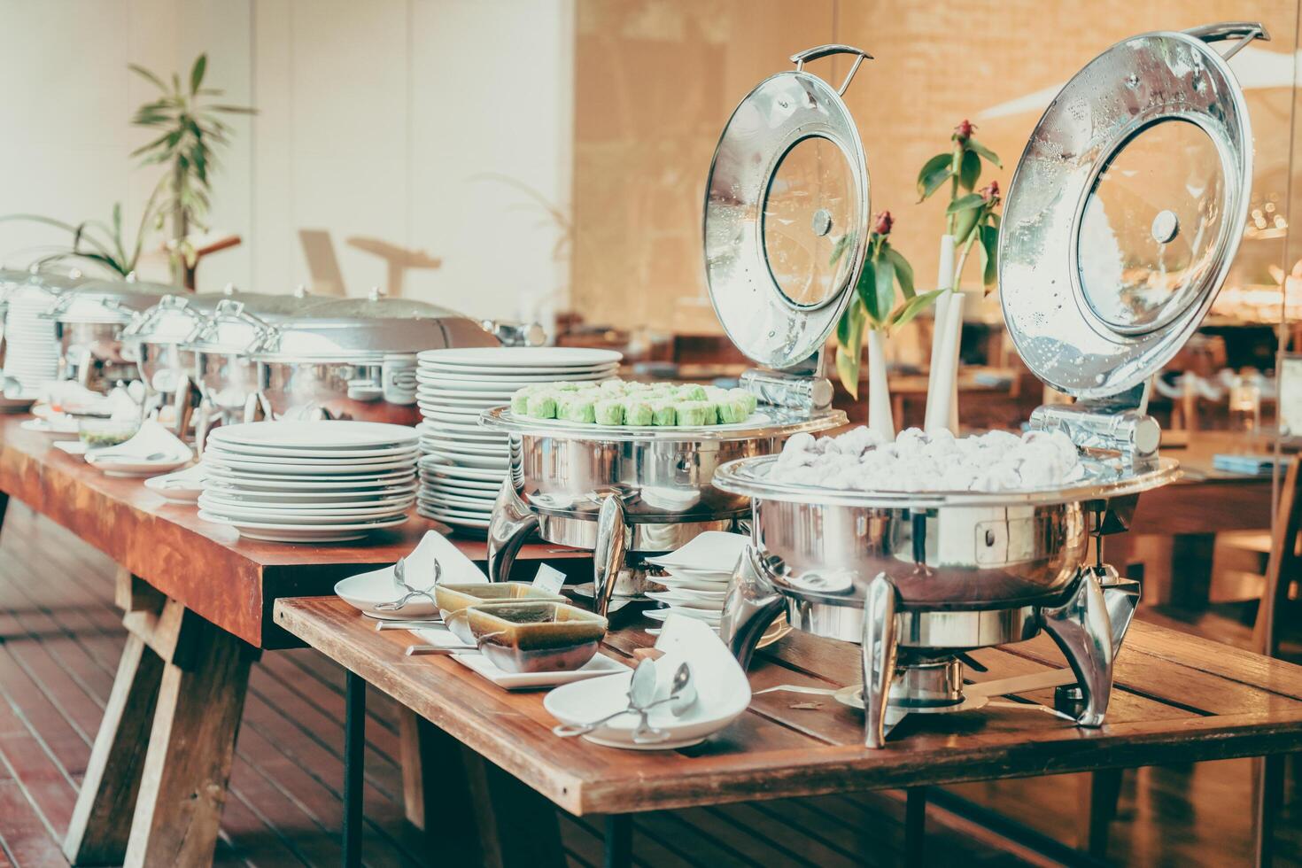 A buffet table with silver dishes and plates photo