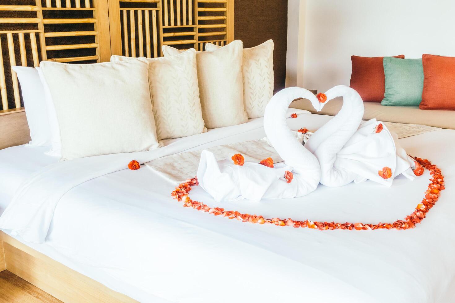 A bed with two swans made out of towels photo