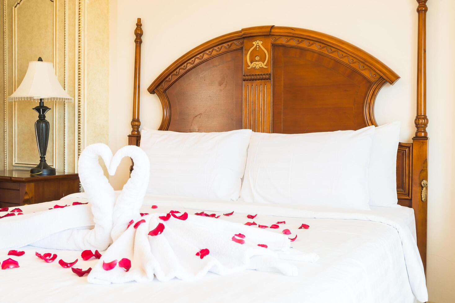A bed with a white sheet photo