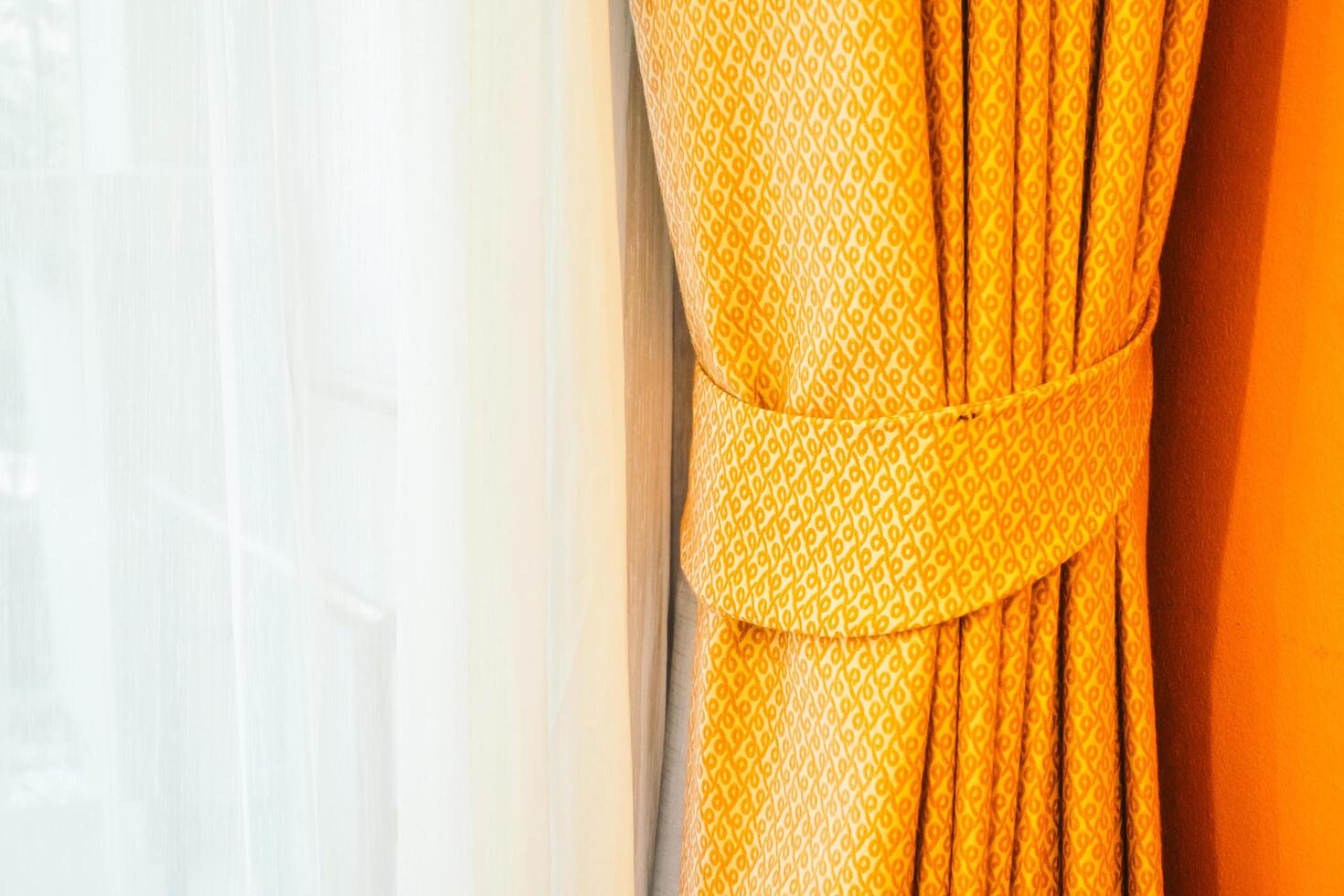 A close up of a curtain with a yellow pattern photo