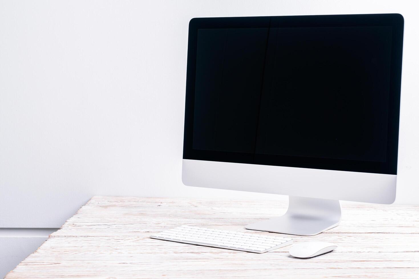 A computer monitor sitting on top of a wooden desk photo