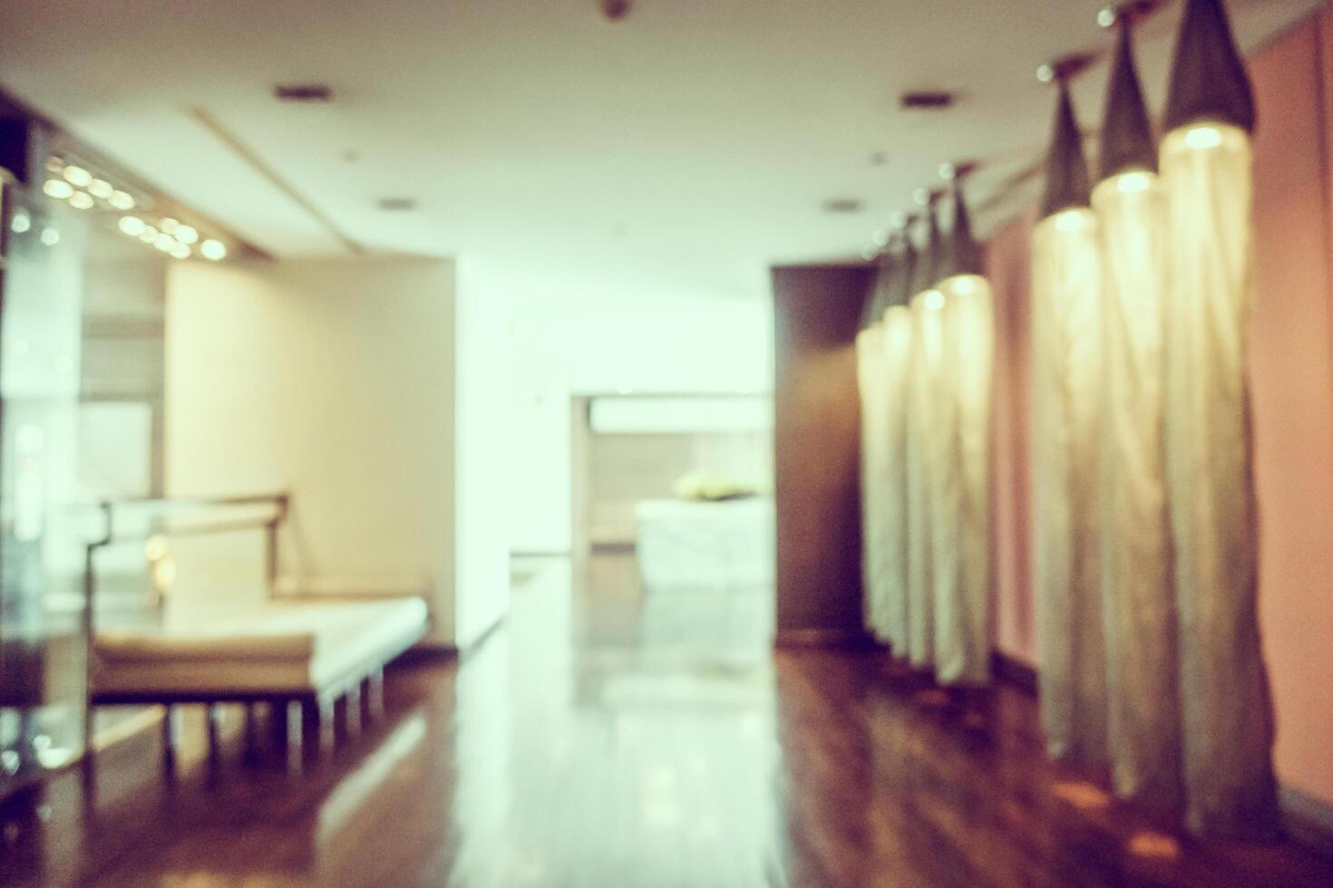 A long hallway with a bench and a wall photo