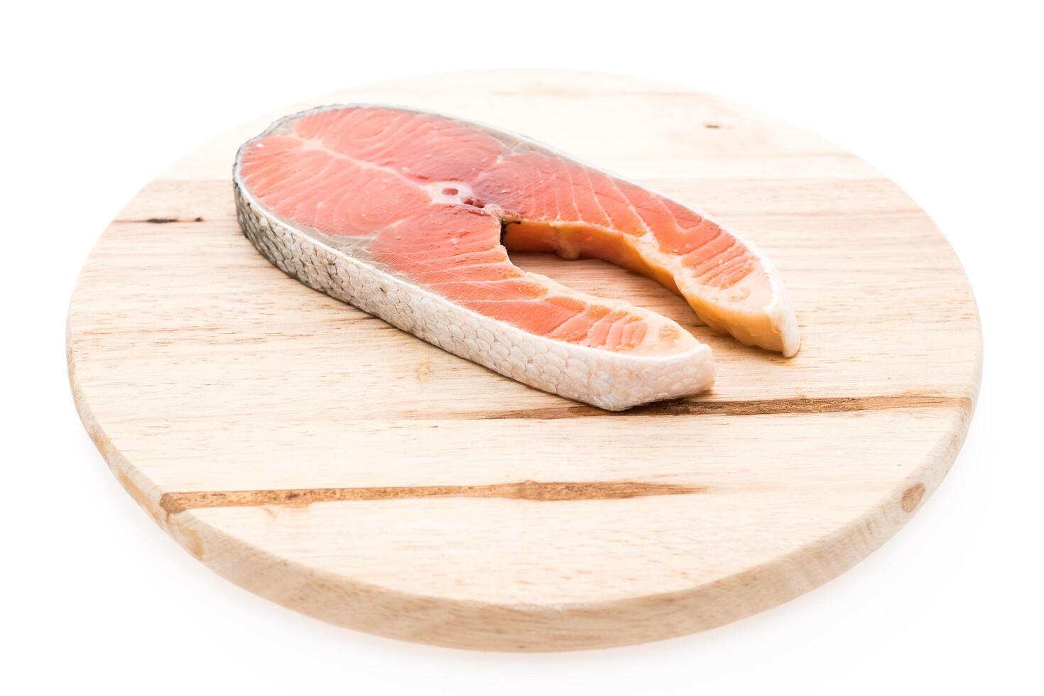 A piece of salmon on a wooden cutting board photo