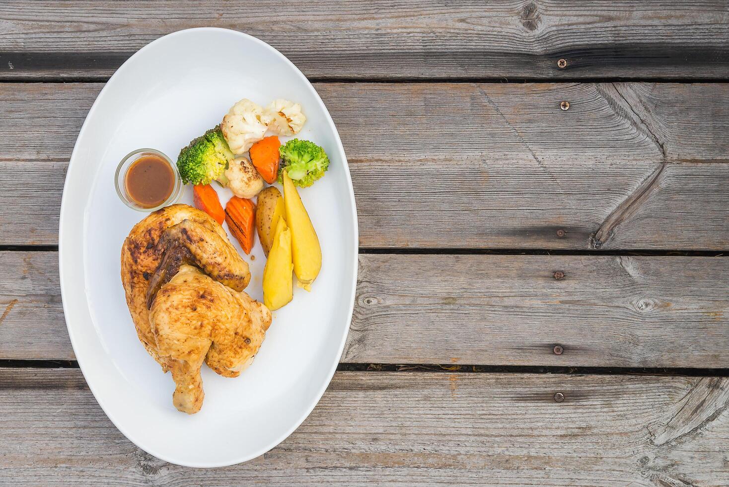 A plate of food on a wooden table photo