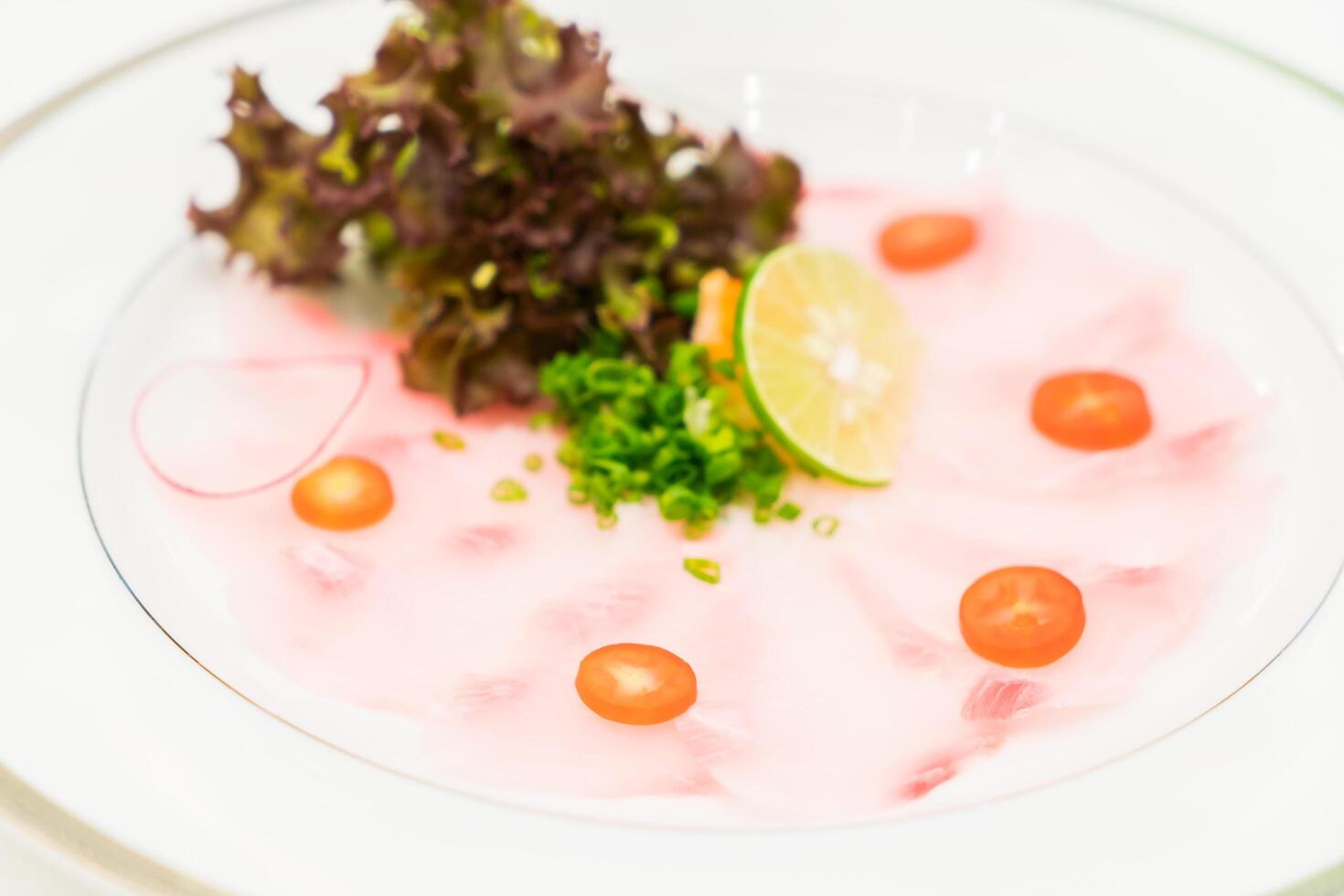 A plate of food with a garnish of tomatoes and a garnish of lettuce photo
