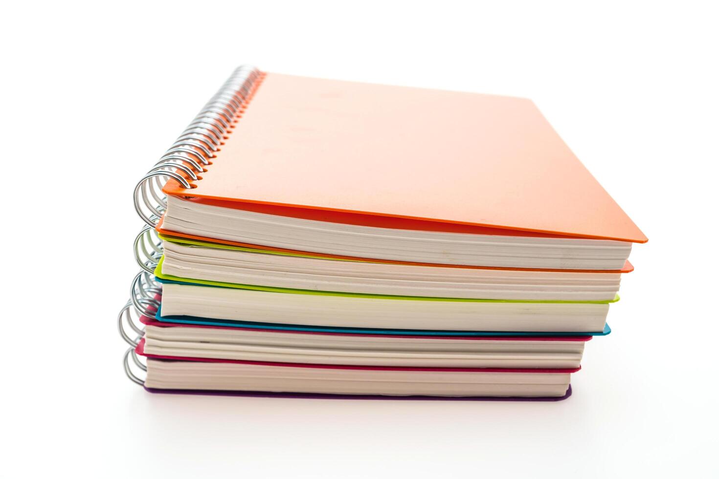 A stack of colorful notebooks on a white background photo