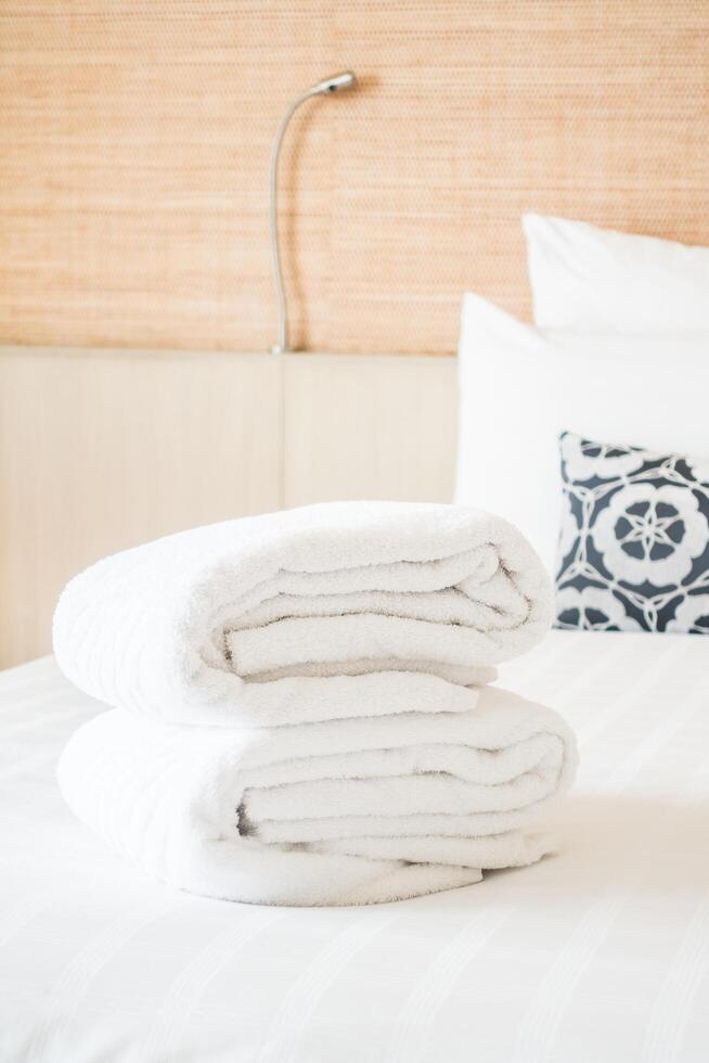 A stack of white towels on a bed photo