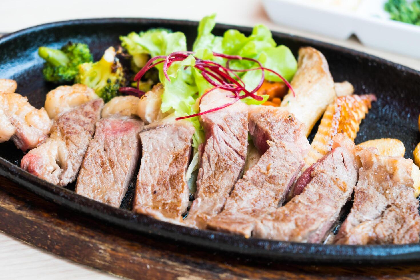 A steak on a black plate photo