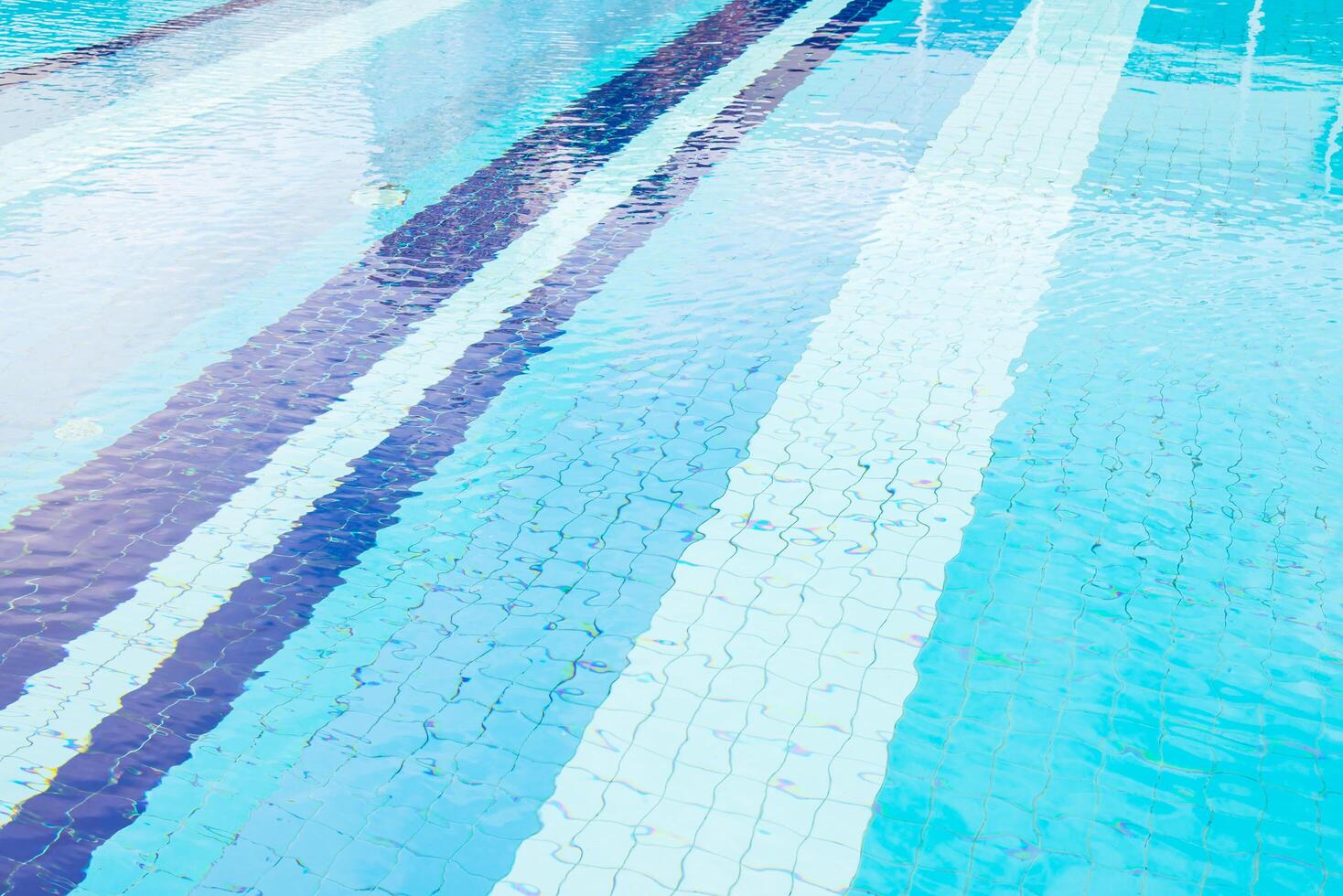 A swimming pool with blue water and white lines photo