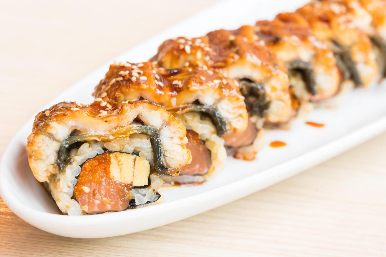A sushi roll on a white plate photo