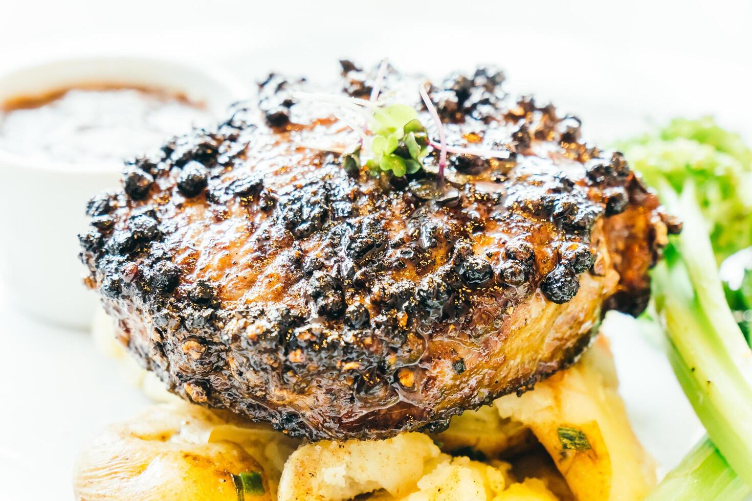 A steak with a side of potatoes and broccoli photo