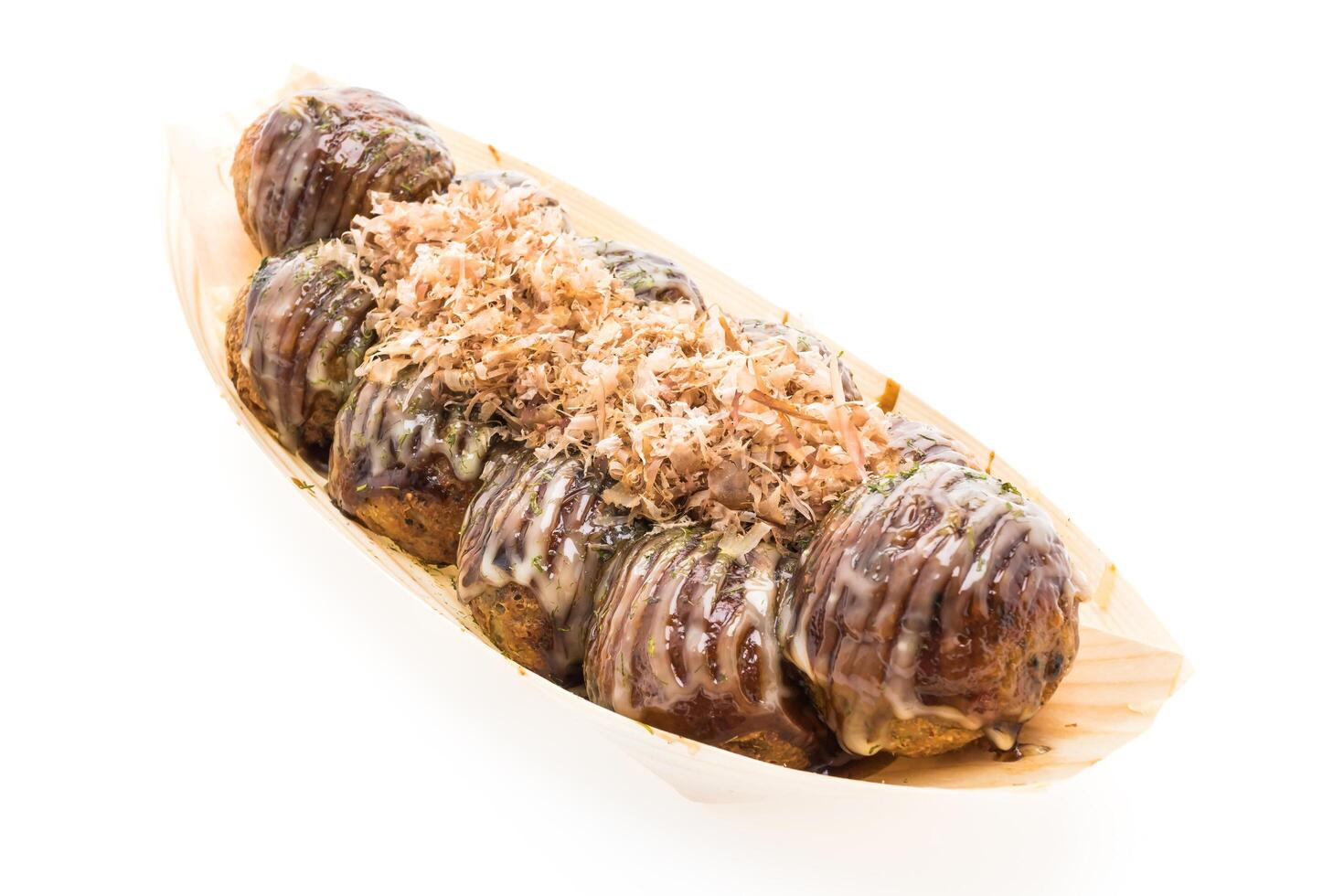 A wooden boat filled with food on a white surface photo
