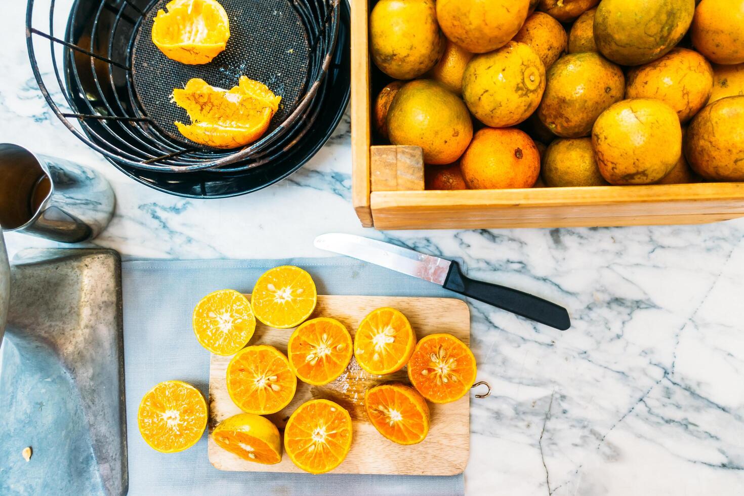 A wooden cutting board with a bunch of oranges on it photo