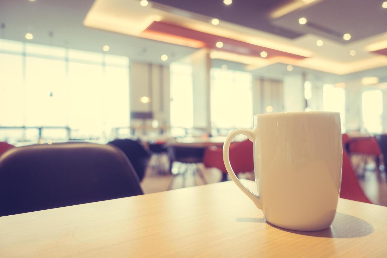 Coffee cup on table in restaurant photo