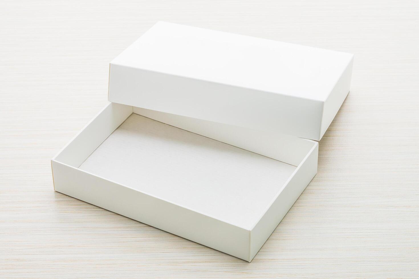 White box with empty space on wooden surface photo