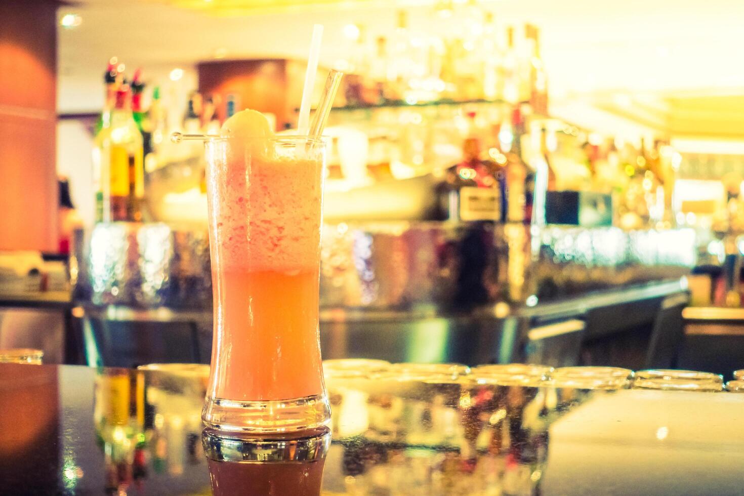 A drink sitting on a bar counter photo