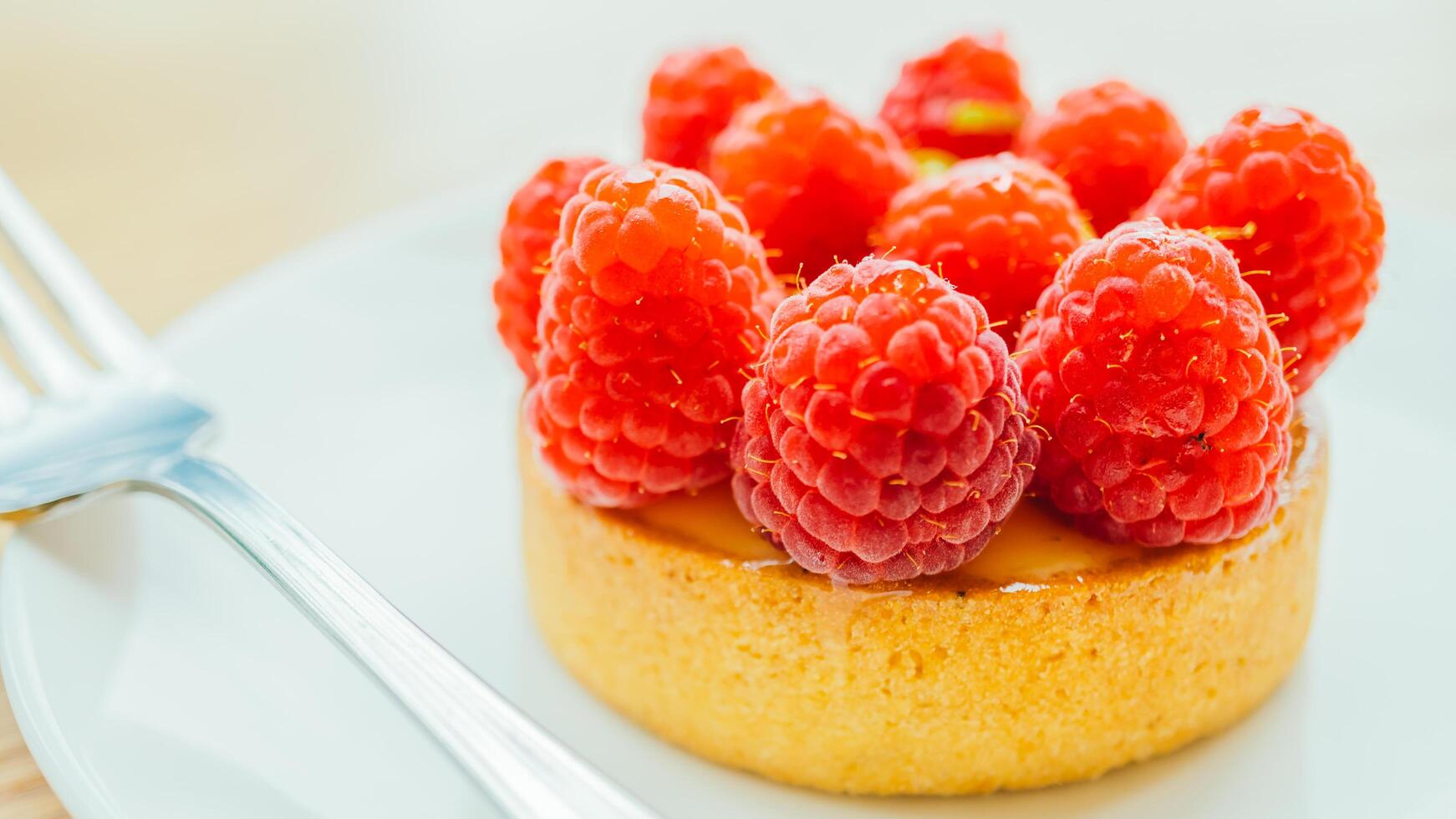 A dessert with raspberries on a plate photo