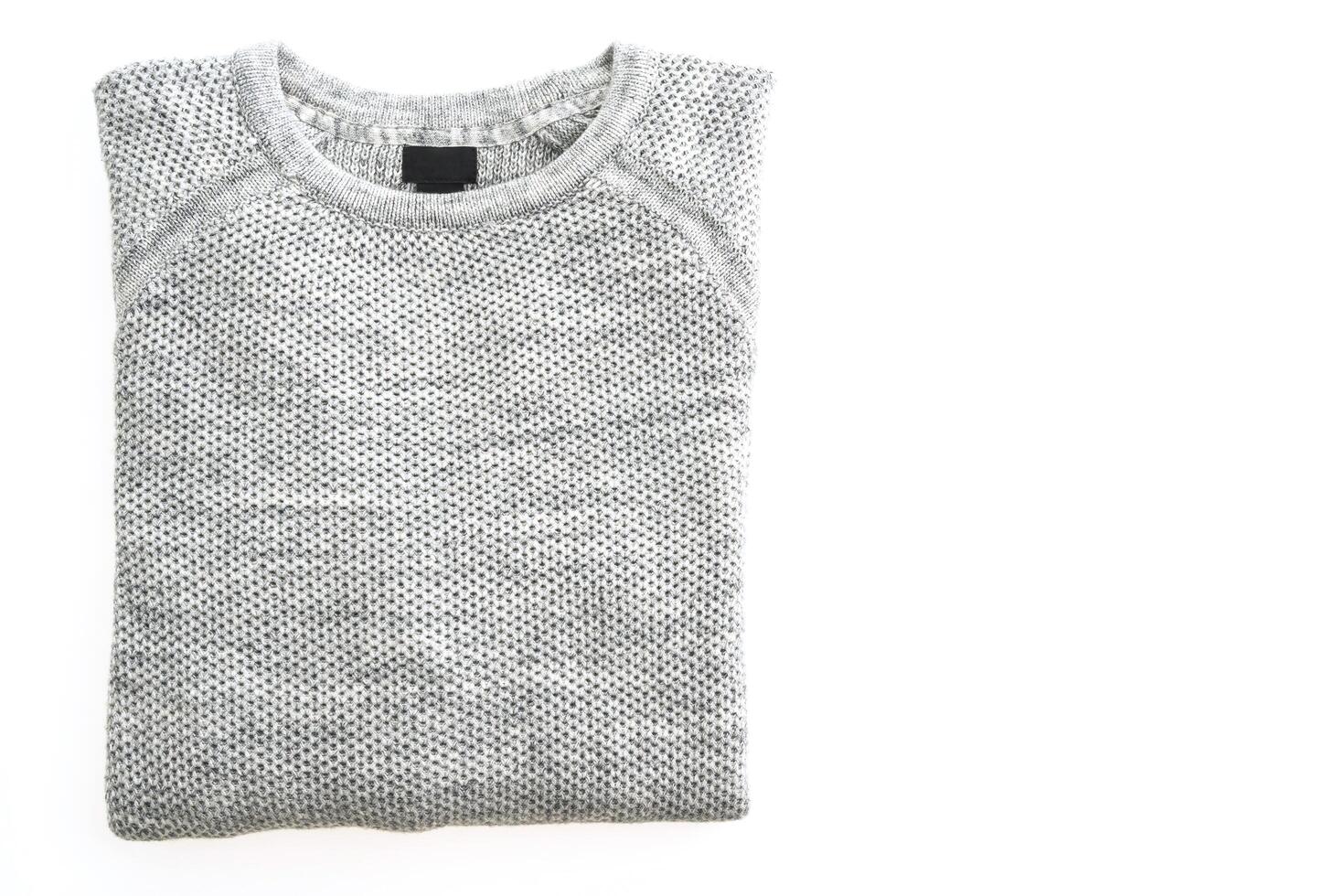 A gray sweater on a white surface photo