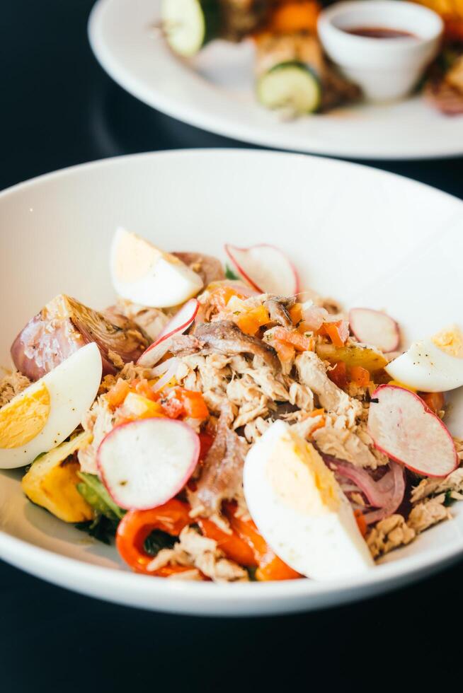 A plate of food with eggs, vegetables and meat photo