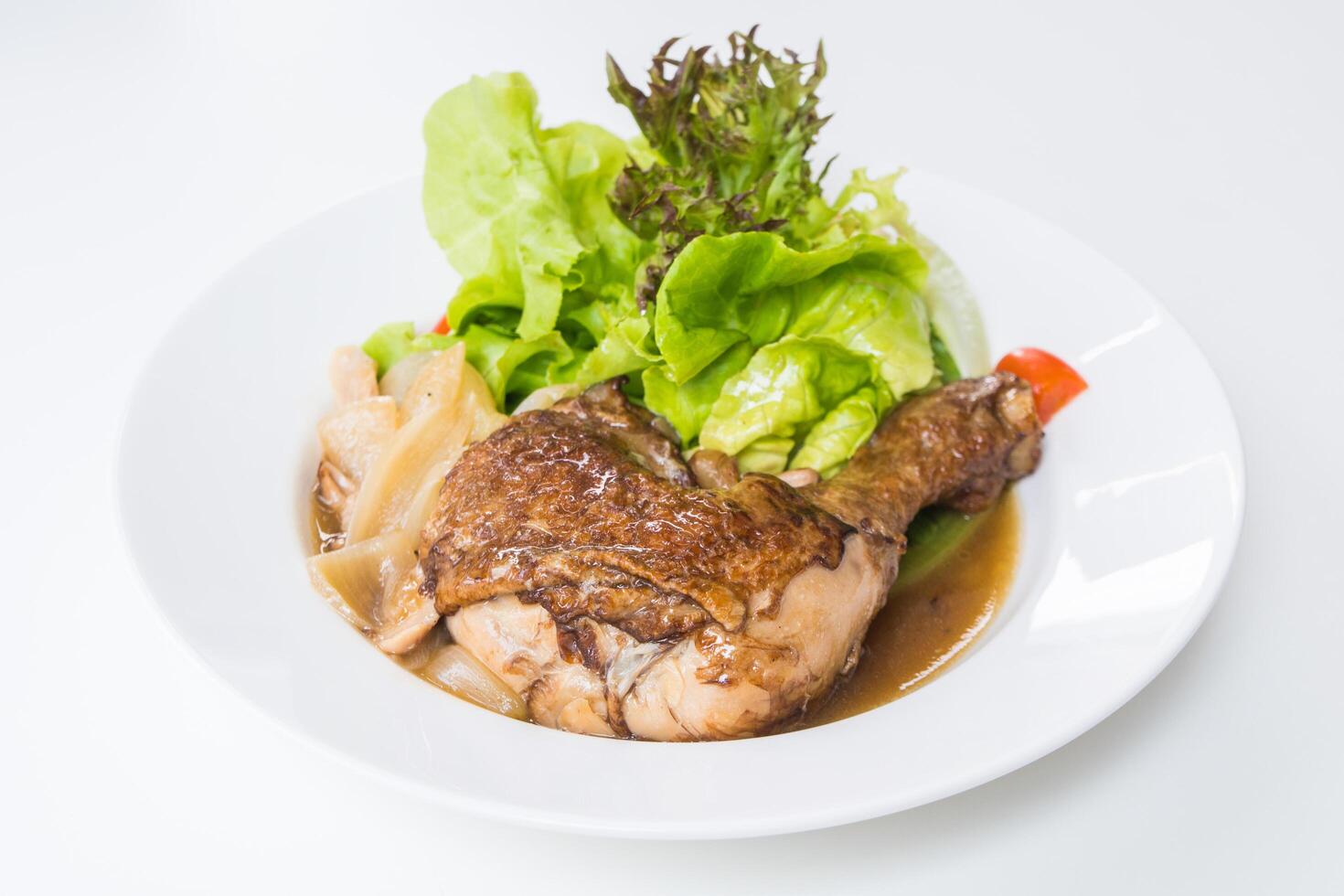 A plate with chicken, lettuce and vegetables photo